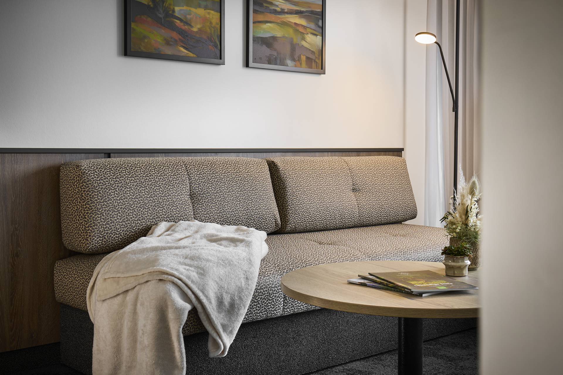 Kuscheldecke auf einem Sofa im Sauerland Stern Hotel Willingen