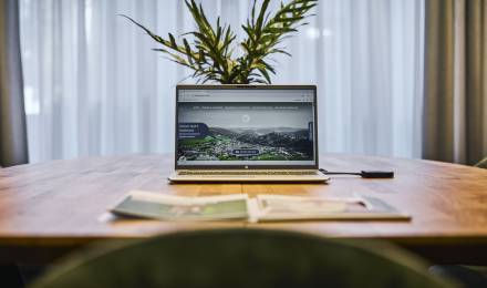 Laptop und Prospekt auf einem Tisch